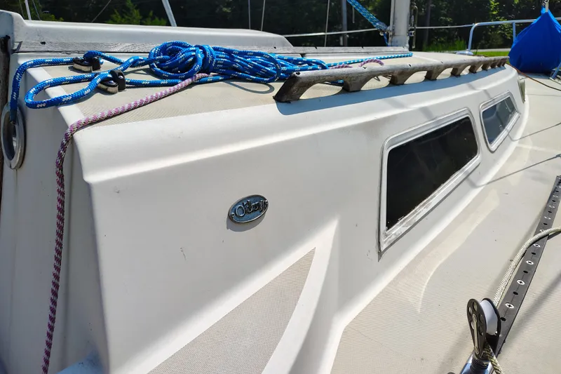 Slide: The Image of 1979 O'Day 28 sailboat deck with ropes and windows in sunlight. - 10