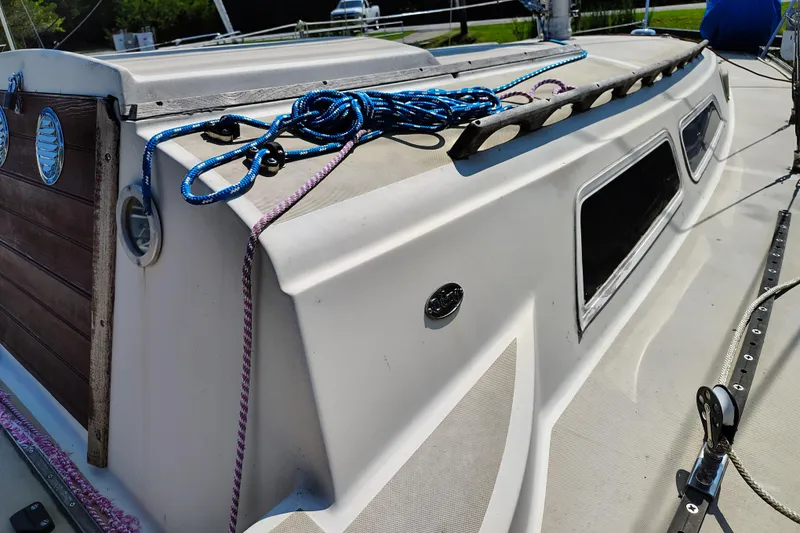 Slide: The Image of 1979 O'Day 28 sailboat deck with ropes and wooden hatch detail. - 11