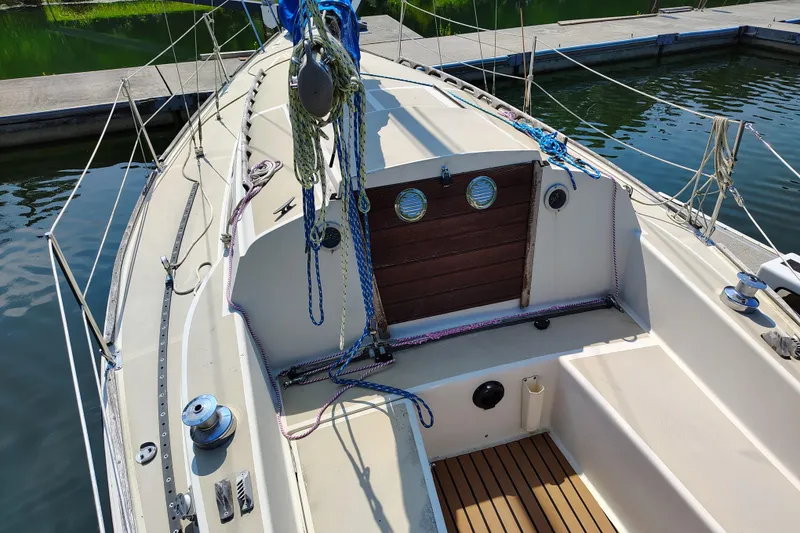 Slide: The Image of 1979 O'Day 28 sailboat deck with ropes and winches at marina. - 13