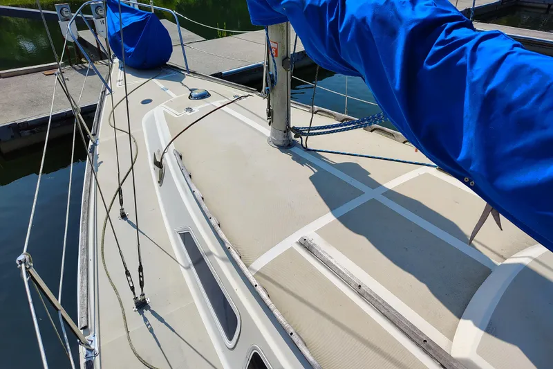Slide: The Image of 1979 O'Day 28 sailboat deck with blue sail cover at marina. - 14