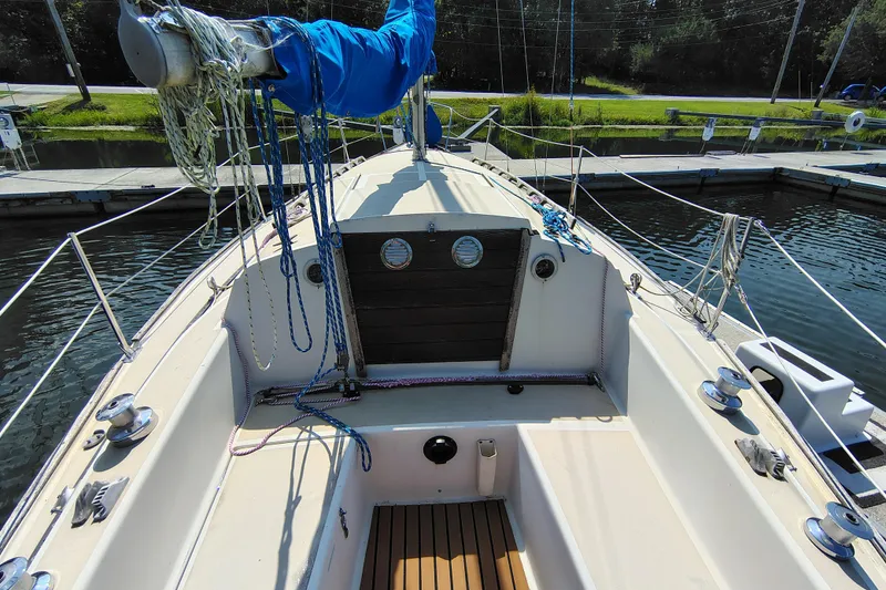 Slide: The Image of 1979 O'Day 28 sailboat cockpit with ropes and winches at a marina dock. - 16