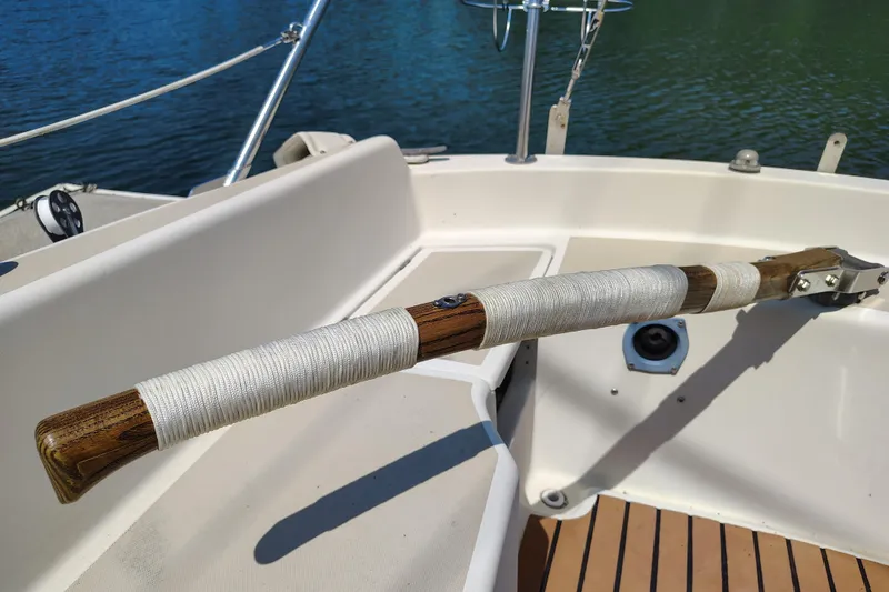 Slide: The Image of 1979 O'Day 28 sailboat cockpit with wooden tiller and white rope wrap. - 17