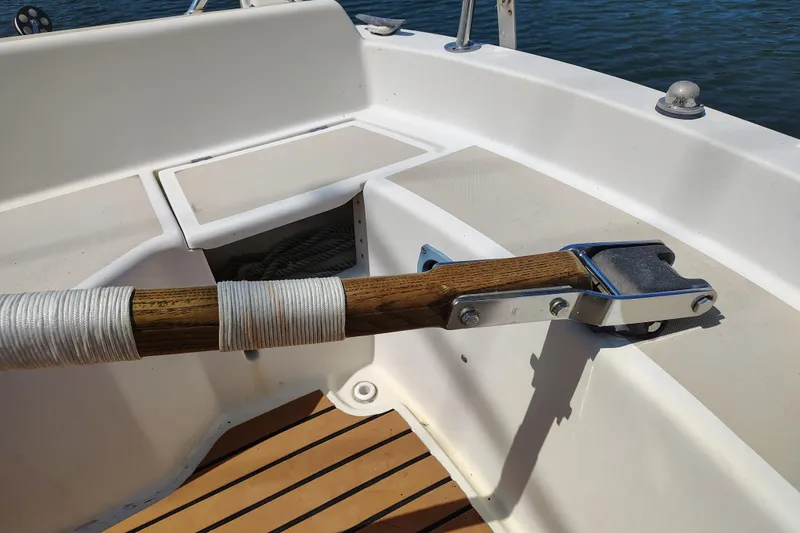 Slide: The Image of 1979 O'Day 28 sailboat cockpit with wooden tiller and white seating. - 18