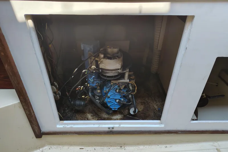 Slide: The Image of 1979 O'Day 28 sailboat engine compartment with visible wiring and components. - 21