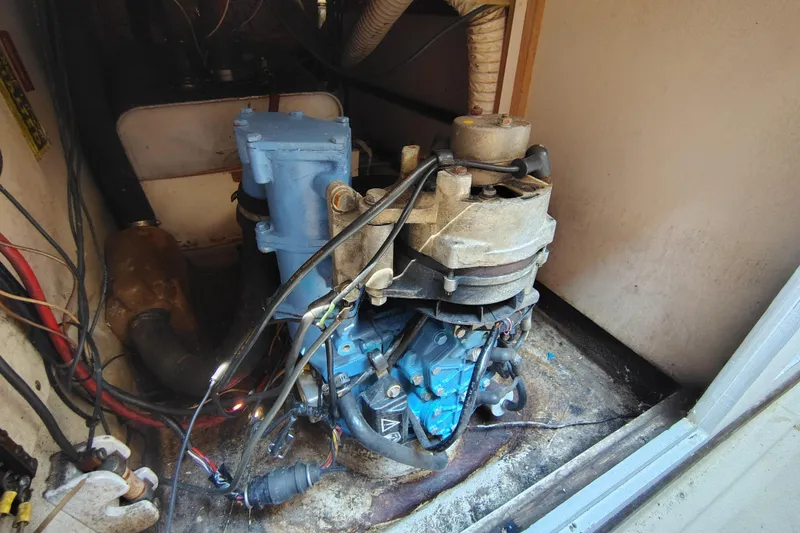 Slide: The Image of 1979 O'Day 28 sailboat engine compartment with visible wiring and components. - 22