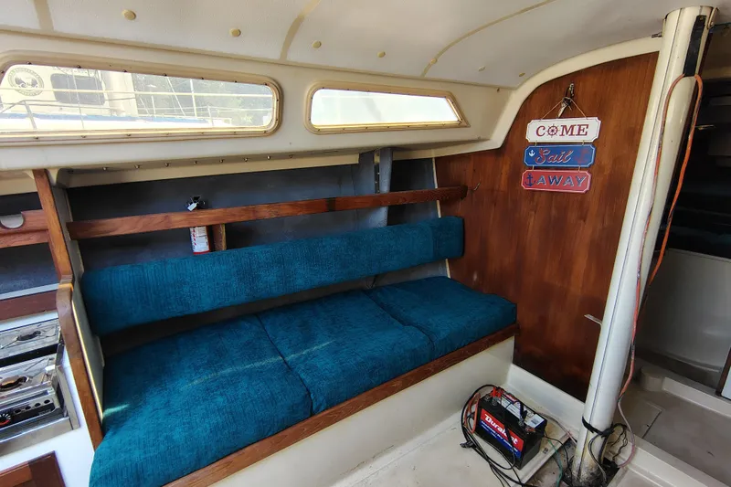 Slide: The Image of Interior of a 1979 O'Day 28 sailboat with blue seating and nautical decor. - 23