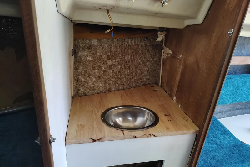 Slide: The Image of 1979 O'Day 28 sailboat interior with wooden countertop and metal sink. - 27