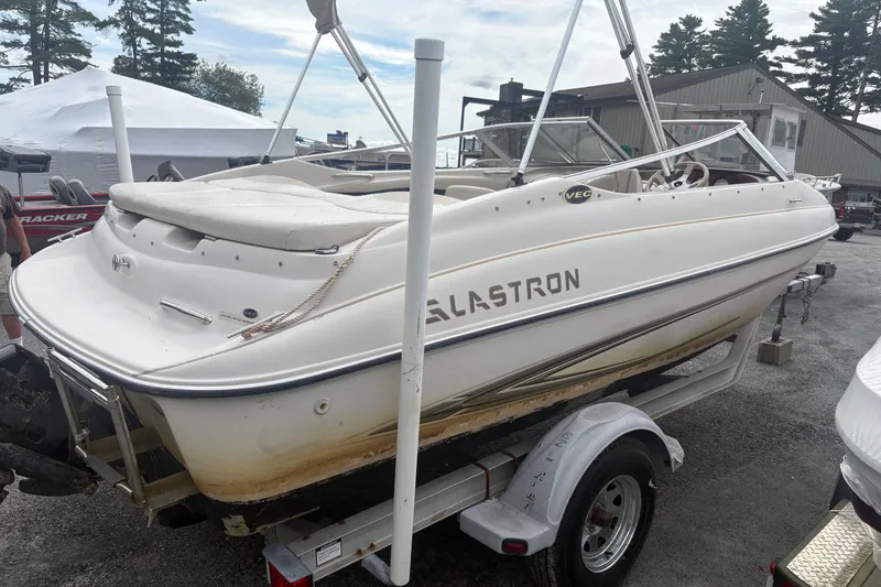 Slide: The Image of 2005 Glastron SX 175 boat on trailer, white exterior, parked outdoors. - 1