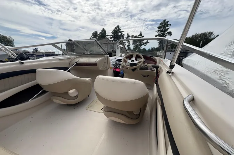 Slide: The Image of Interior of a 2005 Glastron SX 175 boat with beige seating. - 5