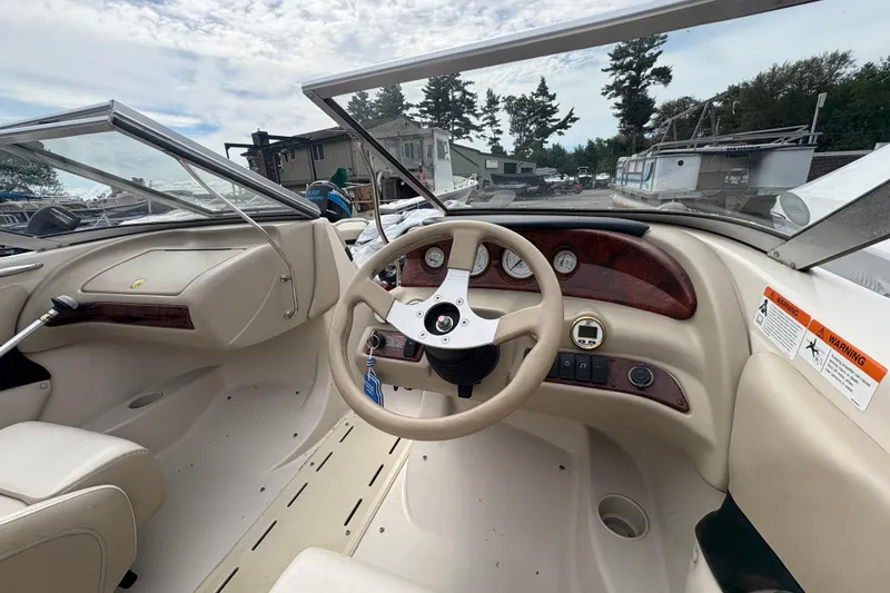 Slide: The Image of 2005 Glastron SX 175 boat interior with steering wheel and dashboard controls. - 6