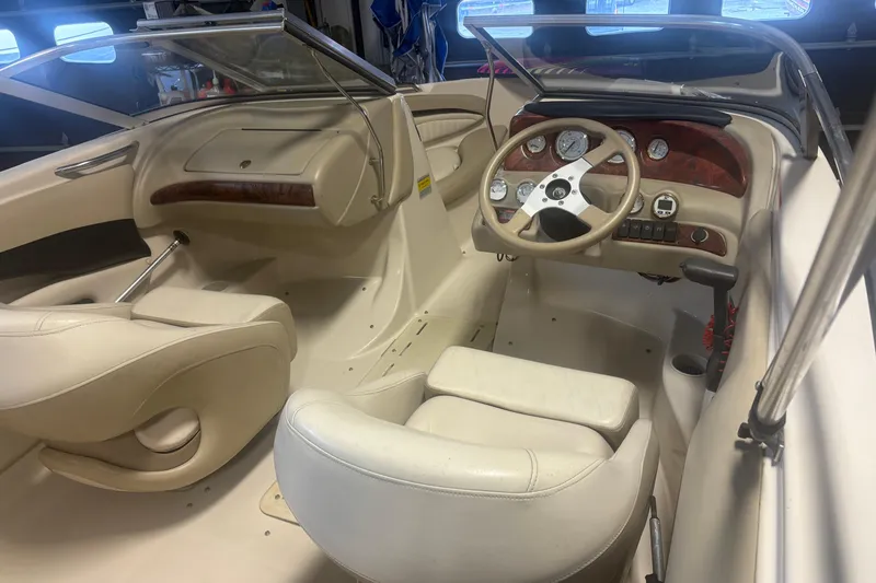 Slide: The Image of 2005 Glastron SX 175 boat interior with steering wheel and dashboard controls. - 8