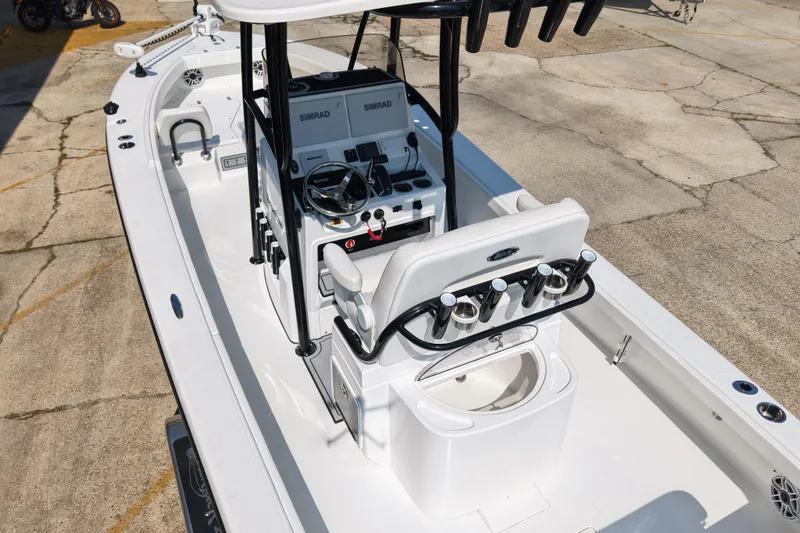 Slide: The Image of 2024 BlackJack 256 Coastal boat interior with steering console and seating. - 3