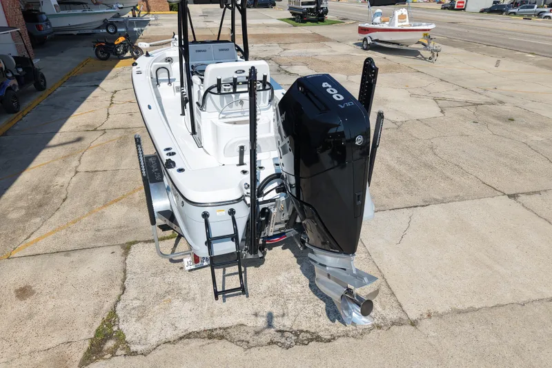 Slide: The Image of 2024 BlackJack 256 Coastal boat with powerful outboard motor, parked on concrete surface. - 4