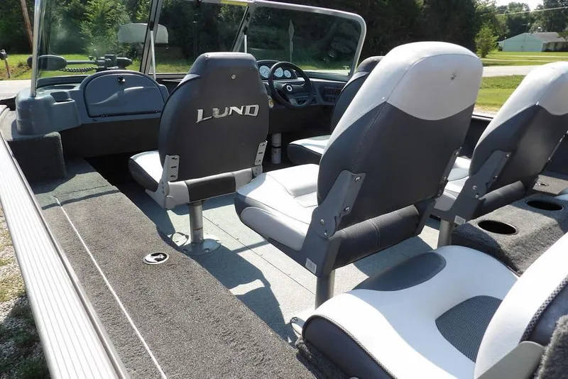 Slide: The Image of 2012 Lund 1775 Impact Sport boat interior with seating and dashboard view. - 10