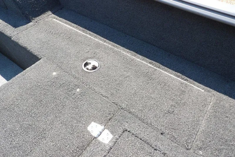 Slide: The Image of Interior view of a 2012 Lund 1775 Impact Sport boat, featuring carpeted flooring. - 15