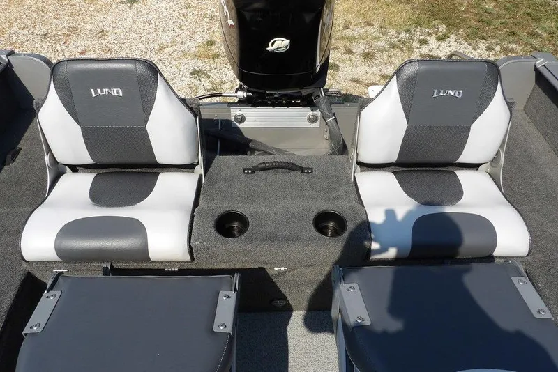 Slide: The Image of 2012 Lund 1775 Impact Sport boat interior with two cushioned seats and storage compartment. - 16