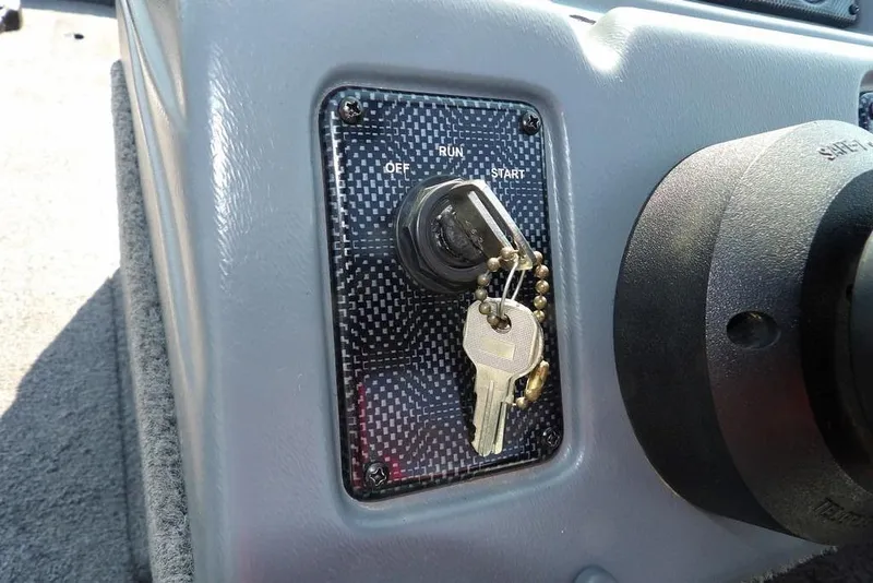 Slide: The Image of Ignition switch with keys in a 2012 Lund 1775 Impact Sport boat. - 18