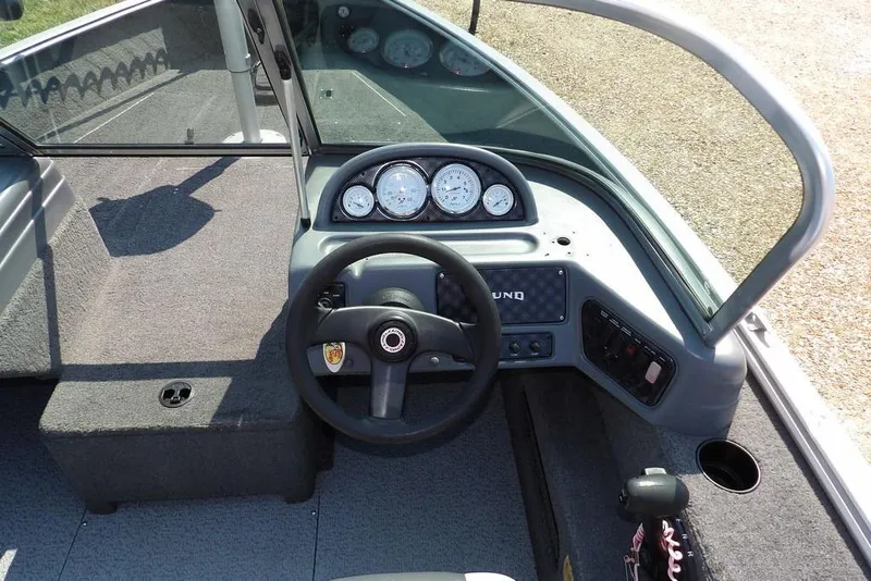 Slide: The Image of 2012 Lund 1775 Impact Sport boat dashboard with steering wheel and gauges. - 19