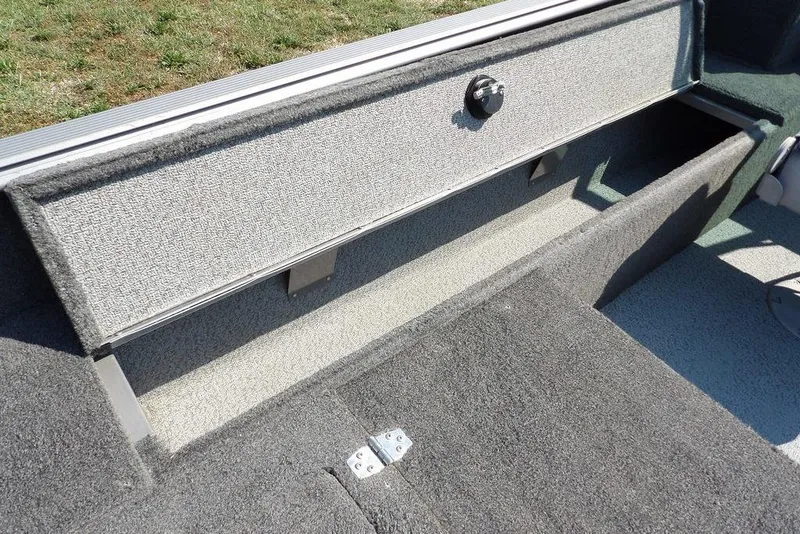 Slide: The Image of 2012 Lund 1775 Impact Sport boat storage compartment with carpeted interior. - 22