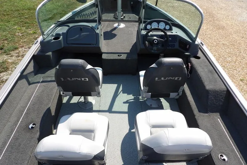 Slide: The Image of 2012 Lund 1775 Impact Sport boat interior with four seats and steering console. - 23