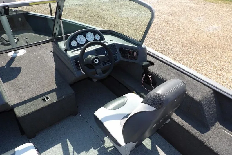 Slide: The Image of 2012 Lund 1775 Impact Sport boat interior with steering wheel and dashboard. - 24