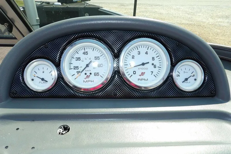 Slide: The Image of Dashboard gauges of a 2012 Lund 1775 Impact Sport boat, showing speed, RPM, fuel, and trim. - 26