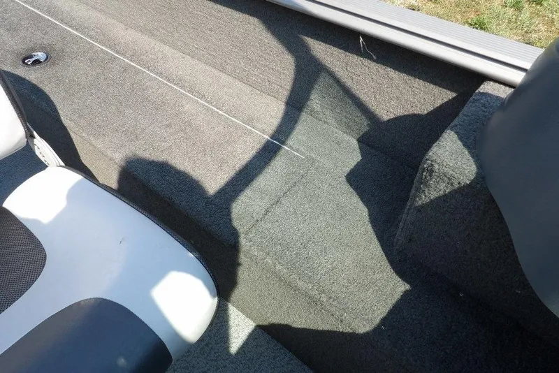 Slide: The Image of Interior of 2012 Lund 1775 Impact Sport boat, featuring carpeted flooring and seating. - 27