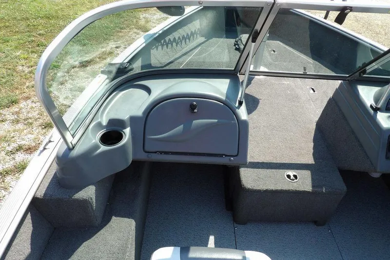 Slide: The Image of Interior of a 2012 Lund 1775 Impact Sport boat, featuring seating and storage areas. - 31