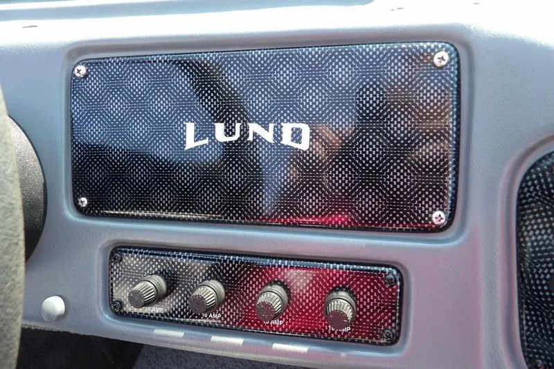 Slide: The Image of Dashboard of a 2012 Lund 1775 Impact Sport boat with control knobs. - 32