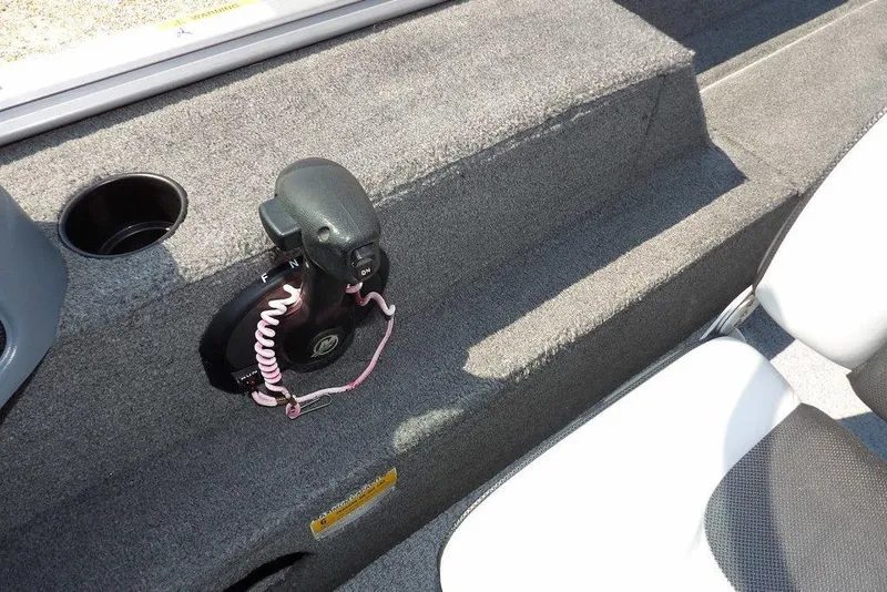 Slide: The Image of 2012 Lund 1775 Impact Sport boat interior with throttle control and cup holder. - 34