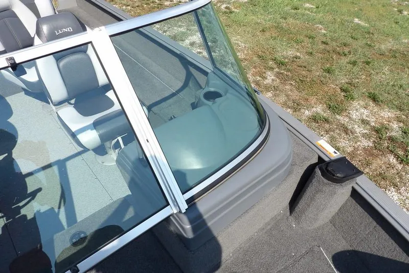 Slide: The Image of 2012 Lund 1775 Impact Sport boat interior with windshield and seating. - 37