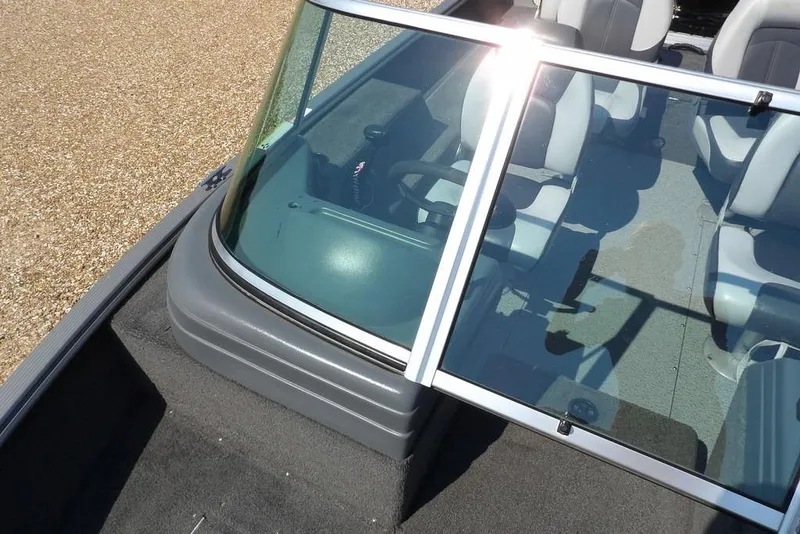 Slide: The Image of 2012 Lund 1775 Impact Sport boat interior with windshield and seating. - 38