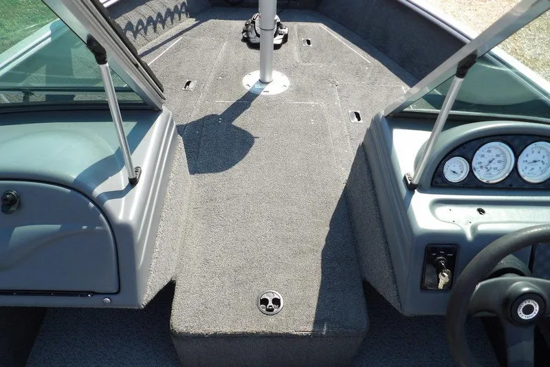 Slide: The Image of 2012 Lund 1775 Impact Sport boat interior with dashboard and carpeted deck. - 39
