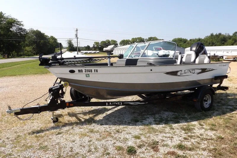 Slide: The Image of 2012 Lund 1775 Impact Sport boat on trailer, parked outdoors. - 4