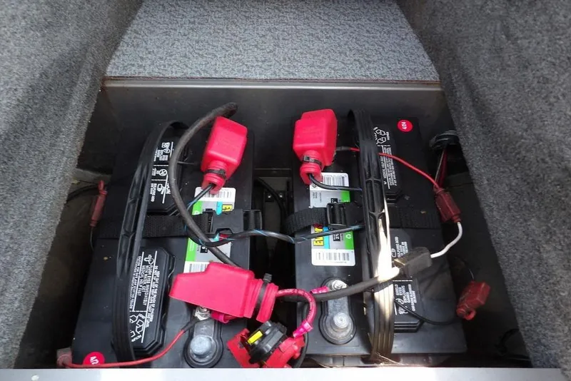 Slide: The Image of Dual batteries in a 2012 Lund 1775 Impact Sport boat, secured with red connectors. - 41