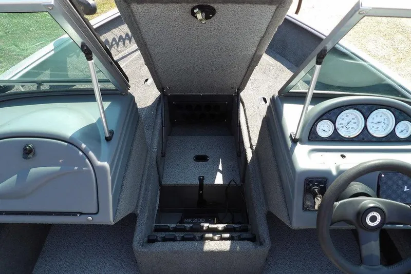 Slide: The Image of 2012 Lund 1775 Impact Sport boat interior with open storage and dashboard view. - 42