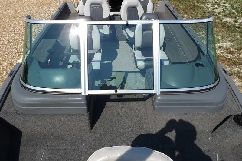 Slide: The Image of 2012 Lund 1775 Impact Sport boat interior with windshield and seating. - 44