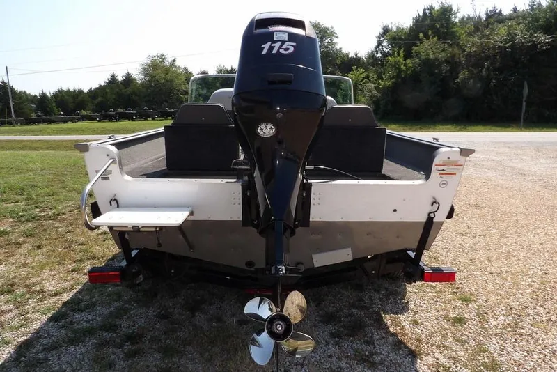 Slide: The Image of 2012 Lund 1775 Impact Sport boat with 115 HP motor, rear view on gravel. - 6