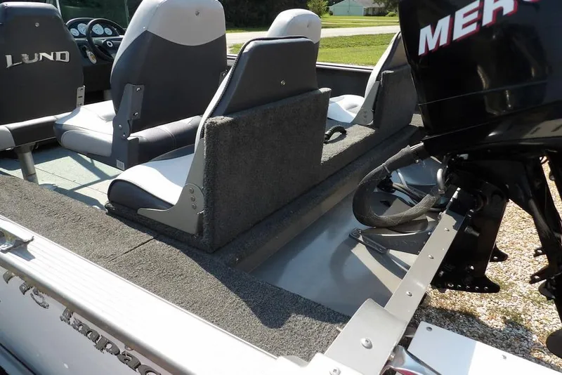 Slide: The Image of 2012 Lund 1775 Impact Sport boat interior with seating and Mercury outboard motor. - 8