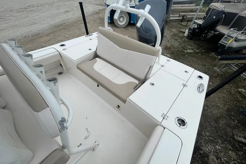 Slide: The Image of 2016 Robalo 246 Cayman boat interior with seating and rod holders. - 10