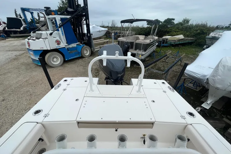 Slide: The Image of 2016 Robalo 246 Cayman boat in storage yard with forklift and covered boats. - 11