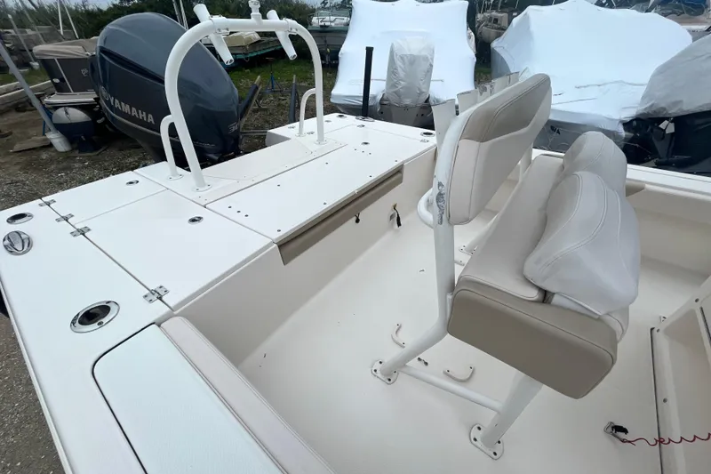 Slide: The Image of 2016 Robalo 246 Cayman boat interior with seating and Yamaha engine. - 12