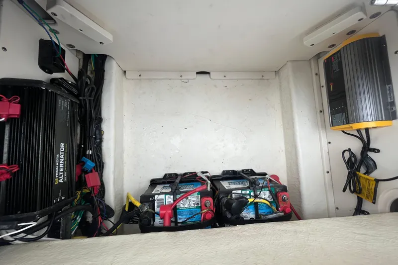 Slide: The Image of 2016 Robalo 246 Cayman boat battery compartment with wiring and alternator. - 14