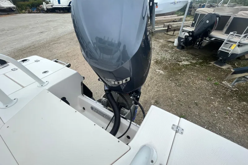 Slide: The Image of 2016 Robalo 246 Cayman boat with Yamaha 300 outboard motor in a marina setting. - 16