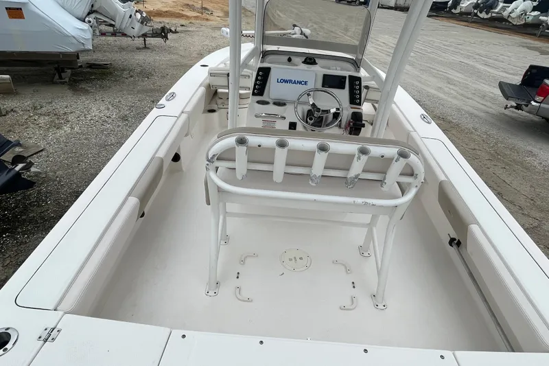 Slide: The Image of 2016 Robalo 246 Cayman boat interior with steering console and rod holders. - 17