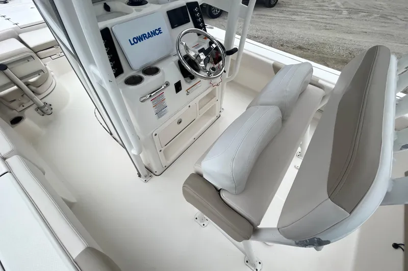 Slide: The Image of 2016 Robalo 246 Cayman boat interior with steering console and seating. - 18