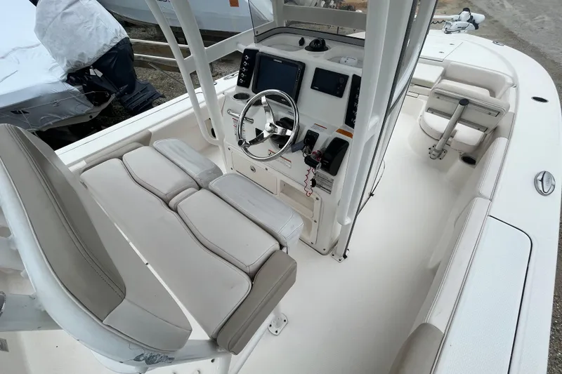 Slide: The Image of 2016 Robalo 246 Cayman boat interior with steering console and seating. - 20