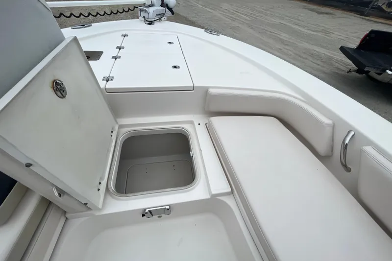 Slide: The Image of 2016 Robalo 246 Cayman boat interior with open storage compartment and seating. - 25