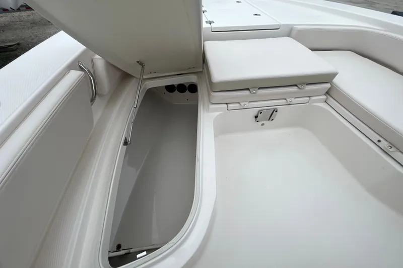 Slide: The Image of 2016 Robalo 246 Cayman boat interior storage compartment with cushioned seating. - 26