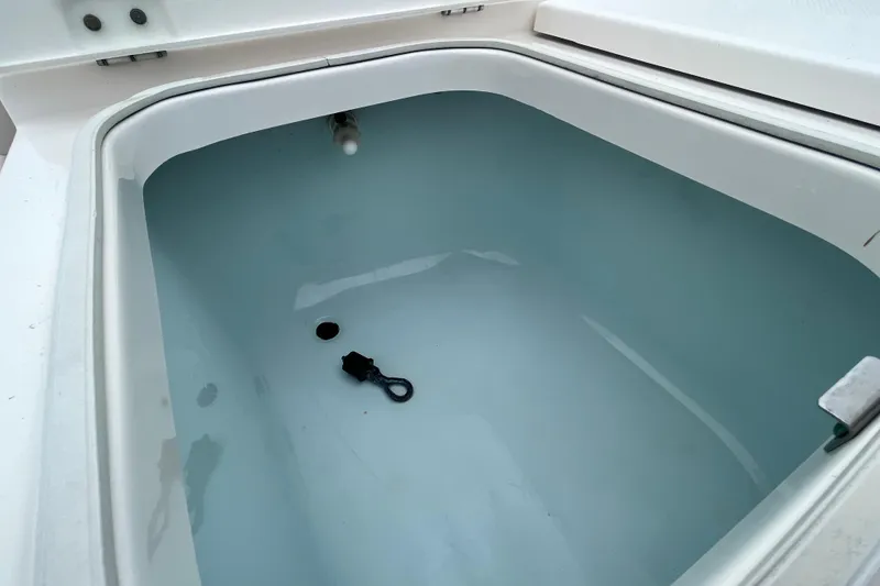 Slide: The Image of Open storage compartment on 2016 Robalo 246 Cayman boat. - 29